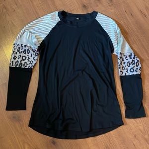 Long sleeve black t-shirt with block patterned arms.